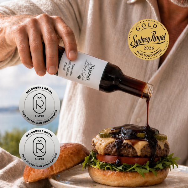 Noosashire Black Garlic Sauce - Gold Medal Winner - being drizzled over a gourmet burger